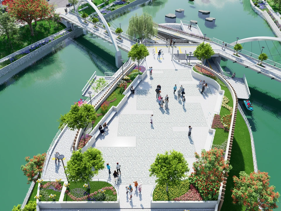 Vista aérea de la plaza del segundo nivel: explanada de piedra con personas, jardineras y árboles, unida por puentes sobre el agua.